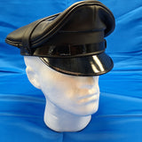 Muir cap with black piping around upper edge
